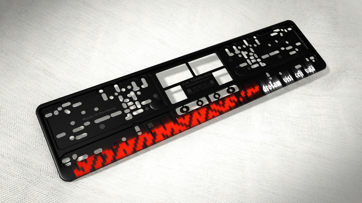 Auto numura turētājs ar latvju rakstiem un uzrakstu - Drošam visi ceļi vaļā Latsign